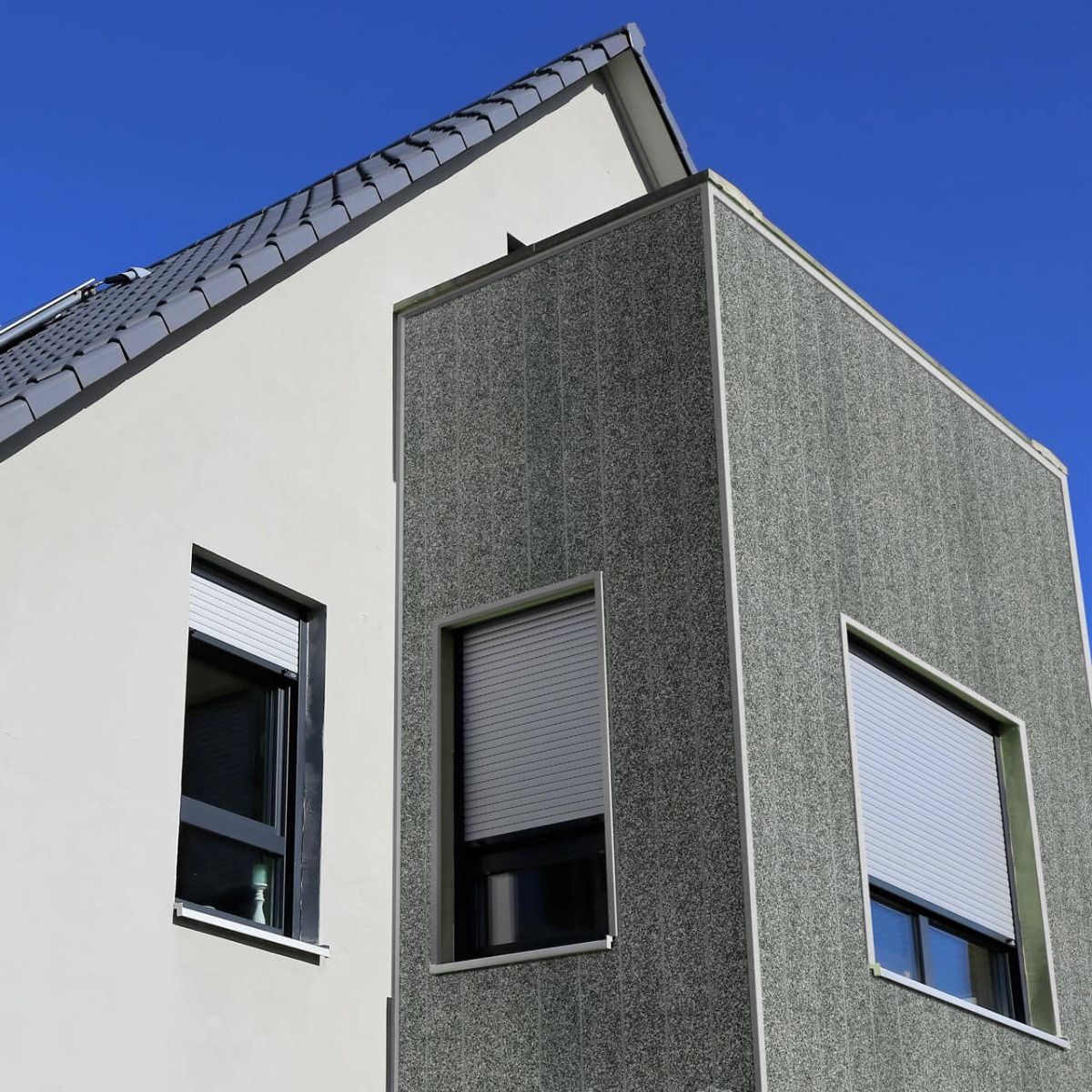 Der Erker dieses Einfamilienhauses wurde mit Fassadenpaneelen in Putzoptik verkleidet. Dank integriertem Lüftungssteg ist hier keine Konterlattung notwendig